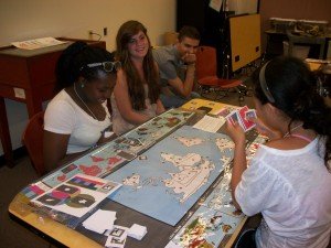 Idee has a winning hand during the climate game at the Museum of Natural History. L-R (Foreground): Idowu Olugbade, Bridget McKenna, Rodrigo Belo, Yiyi Zhang